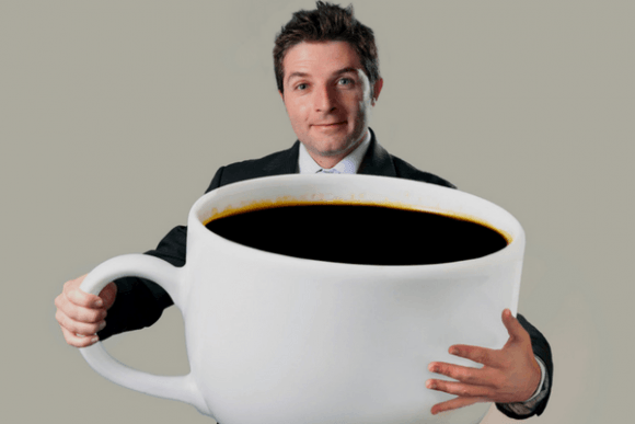 Man Holding Over Sized Coffee Cup