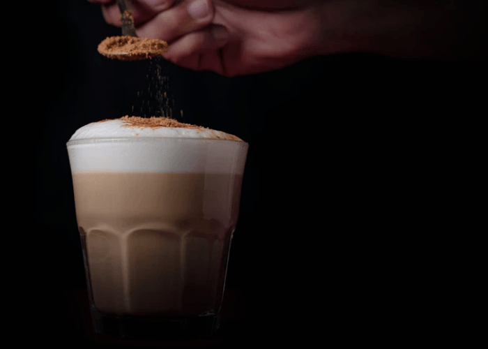 A Glass Of Espresso Topped With Crema On Black Background