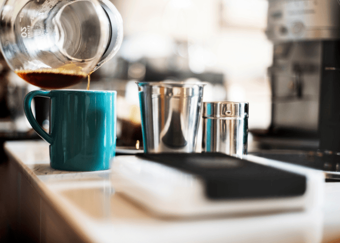 Coffee Being Poured Into A Cup On The Counter