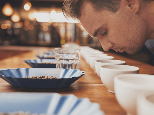 Man Smelling Aromatic Coffee At Tasting