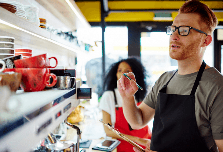 Male Coffee Shop Owners Counting Cups For Inventory