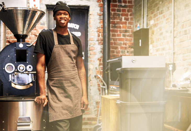 Employee Smiling at the camera in a coffee roasting shop