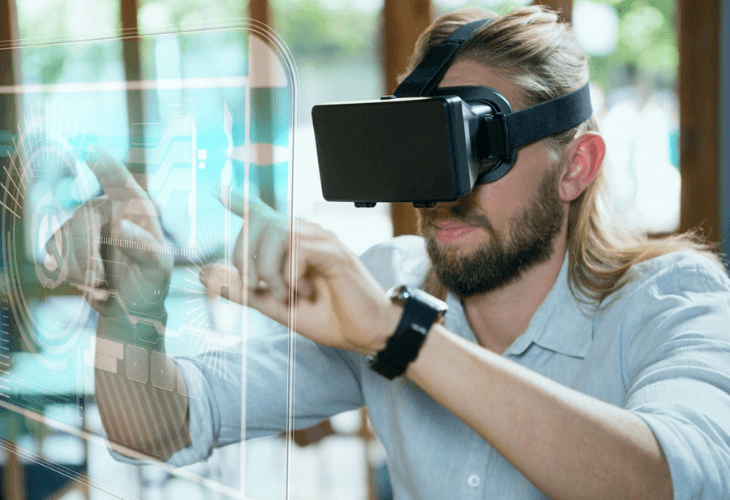 Man in VR headset touching interface 