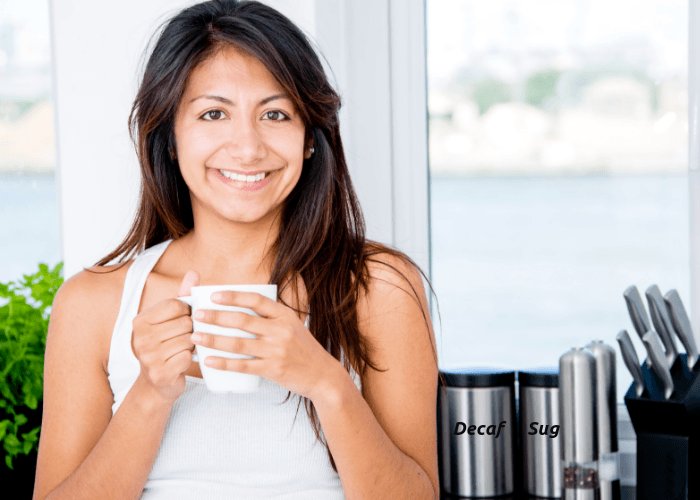 Young woman enjoying a cup of decaffeinated coffee 