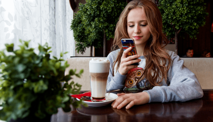 Young woman enjoying a beverage at her local coffee house