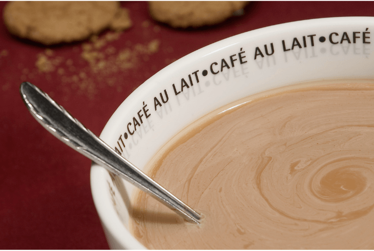 A cafe au lait with a spoon to stir it