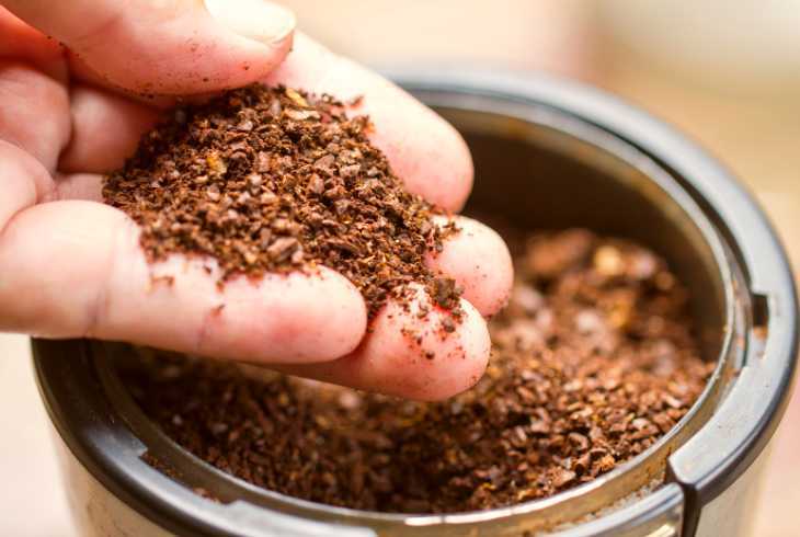 Coarse ground coffee in coffee grinder