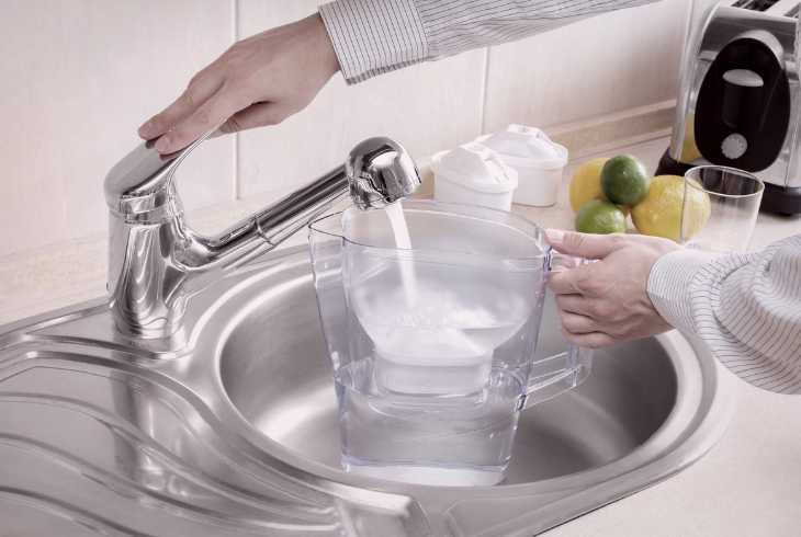 Filling up filtered water jug in kitchen sink