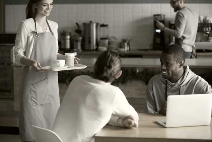 Two men getting coffee in a homeless shelter