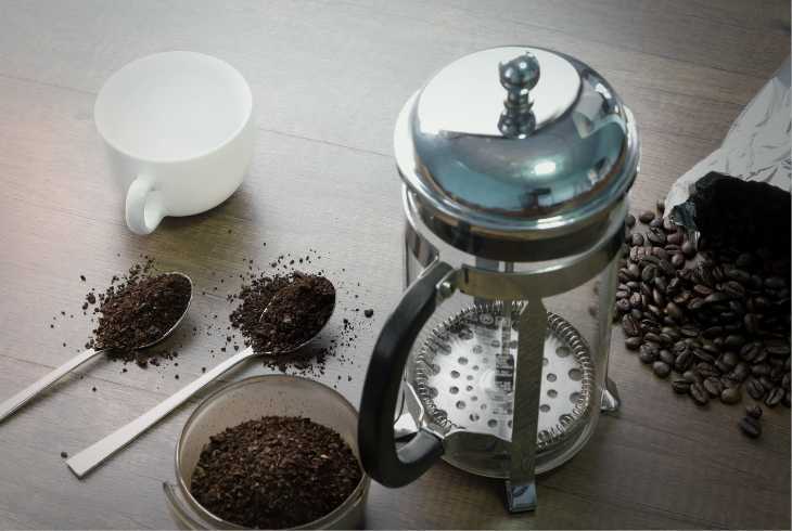 French press with medium roasted coffee and beans