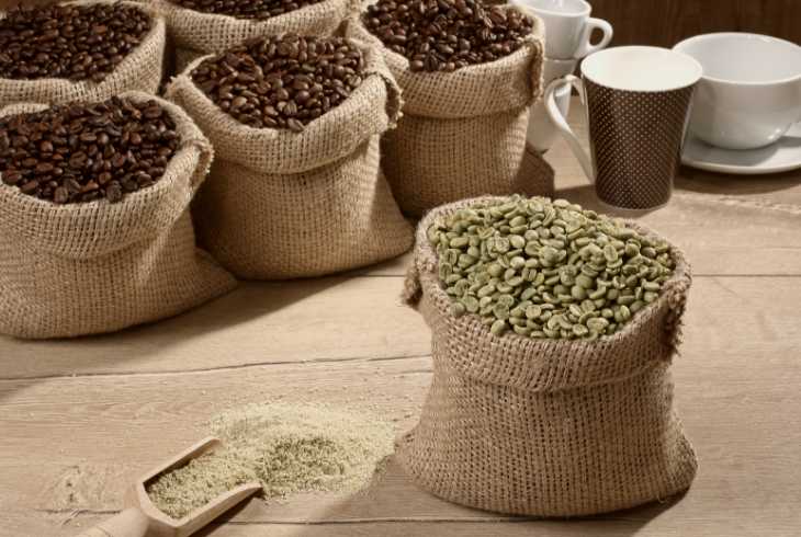 Different grades of coffee beans in burlap bags