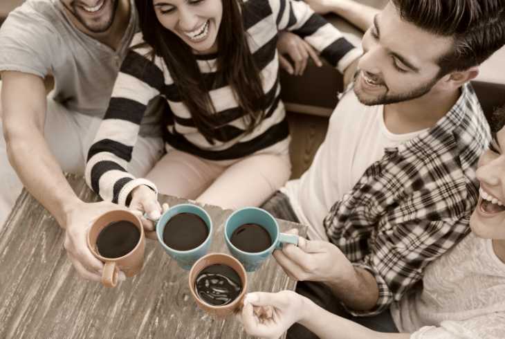 Four friends socializing with coffee