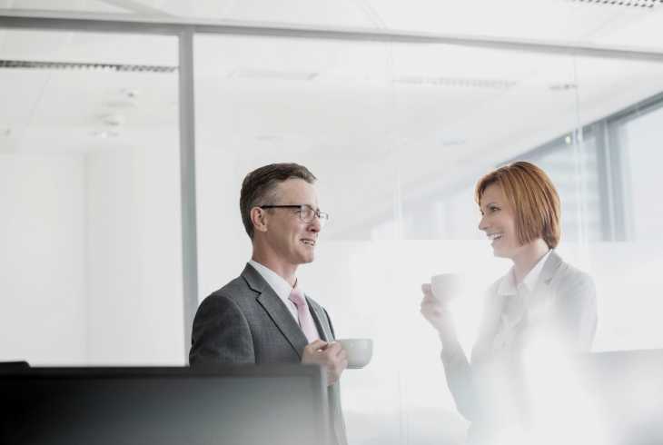 Two employees enjoying a cup of coffee together