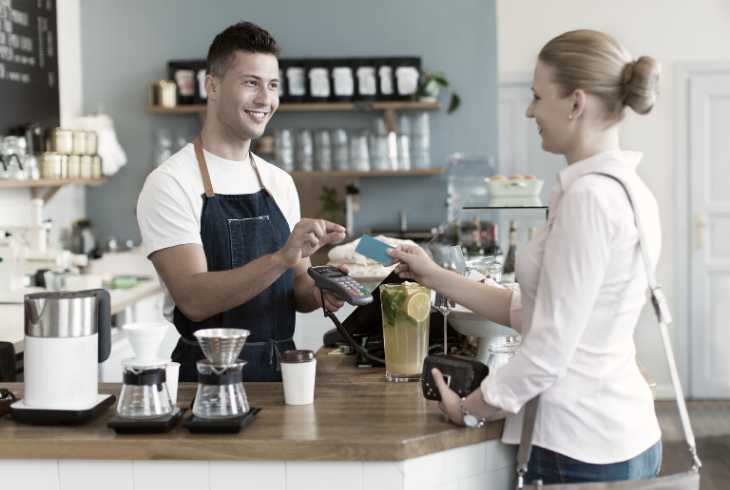 Coffee shop owner serving a customer